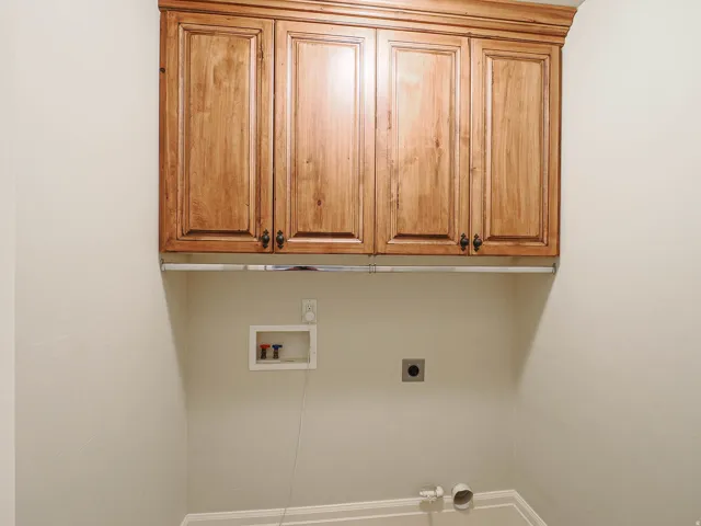 Laundry area with cabinet space, hookup for a washing machine, and electric dryer hookup