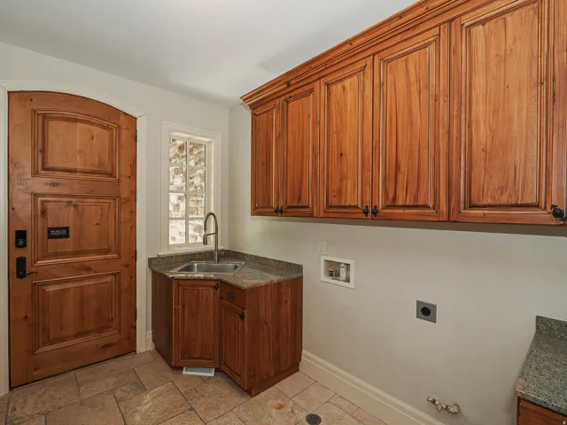Laundry area with washer hookup, cabinet space, stone tile flooring, hookup for an electric dryer, and hookup for a gas dryer