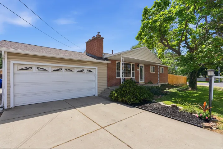 Brick and siding exterior featuring an attached two-car garage with decorative window inserts