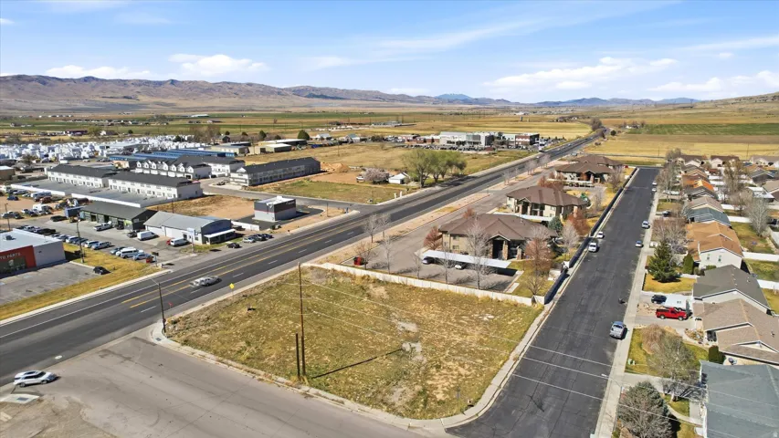 View of property location with mountains and nearby suburban area