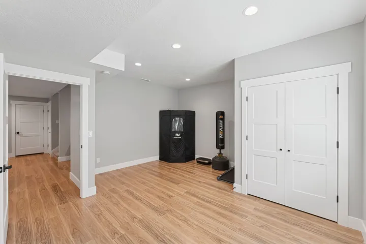 Game room with light wood finished floors, recessed lighting, and a textured ceiling