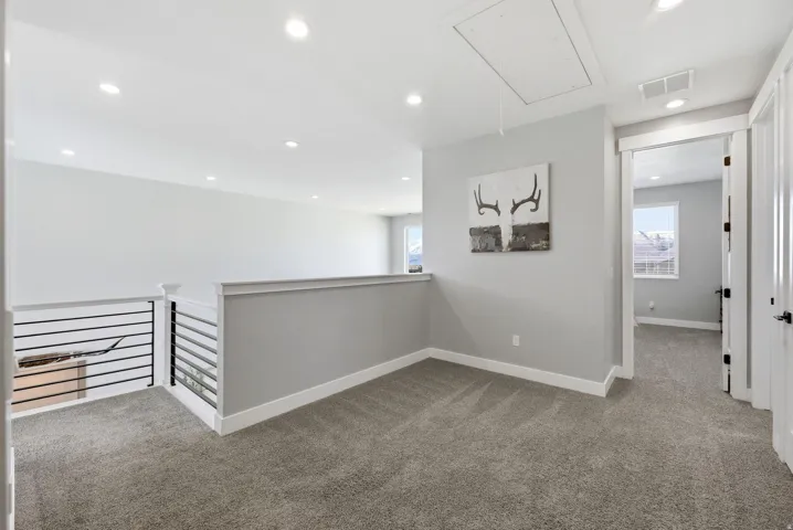Corridor featuring carpet, an upstairs landing, and recessed lighting