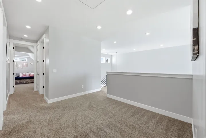 Unfurnished room featuring light carpet and recessed lighting
