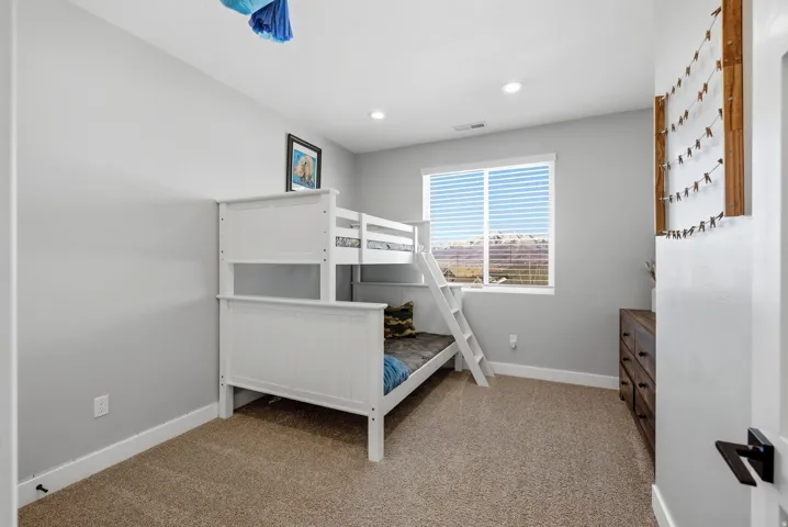 Bedroom featuring light colored carpet and recessed lighting