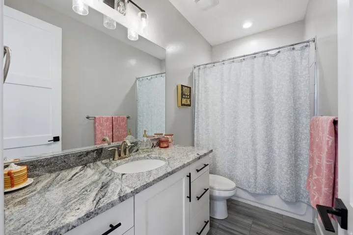 Bathroom featuring vanity and shower / tub combo with curtain
