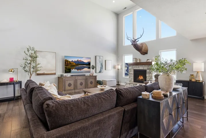 Living area featuring hardwood / wood-style flooring, a high ceiling, and a fireplace
