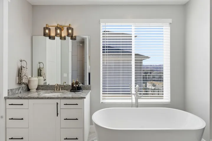 Full bathroom featuring vanity and a soaking tub