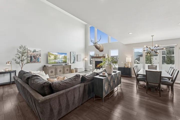 Expansive living area featuring high ceilings and dark wood-finish flooring