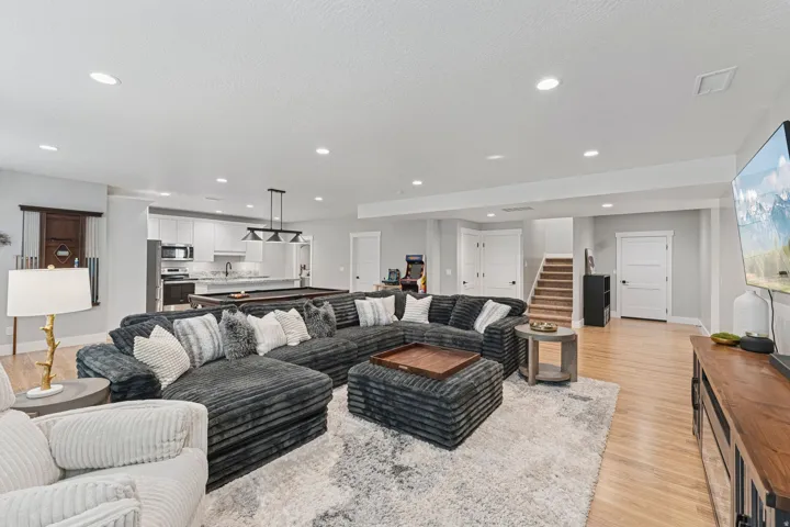 Living area with light wood-style floors, recessed lighting, billiards table, and a textured ceiling