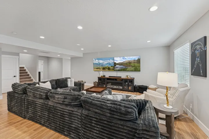 Living room featuring light wood-style flooring, recessed lighting, and a textured ceiling
