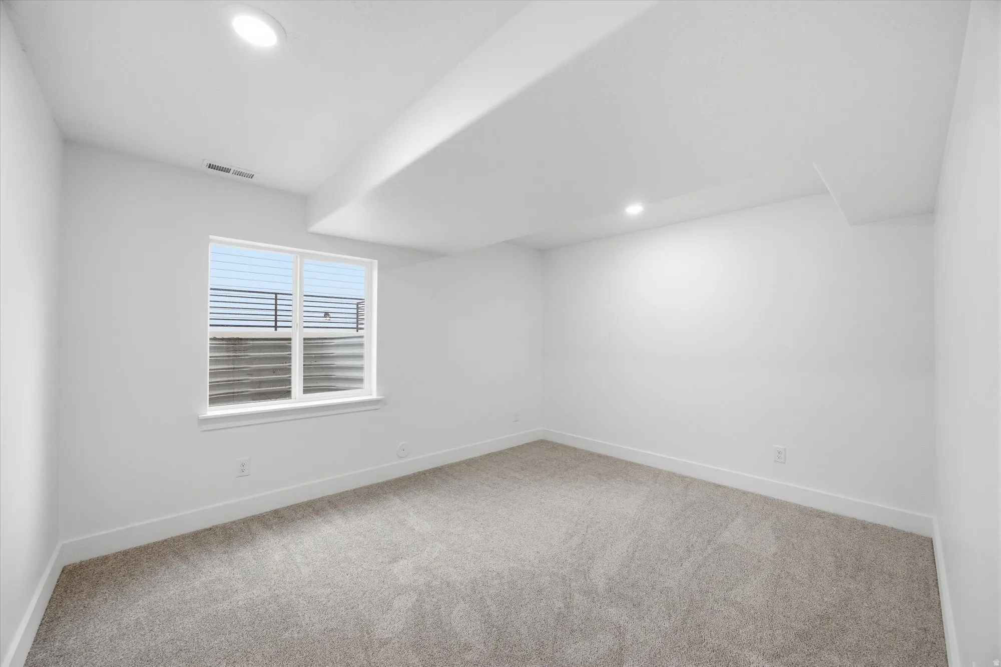 Unfurnished room featuring light carpet and recessed lighting
