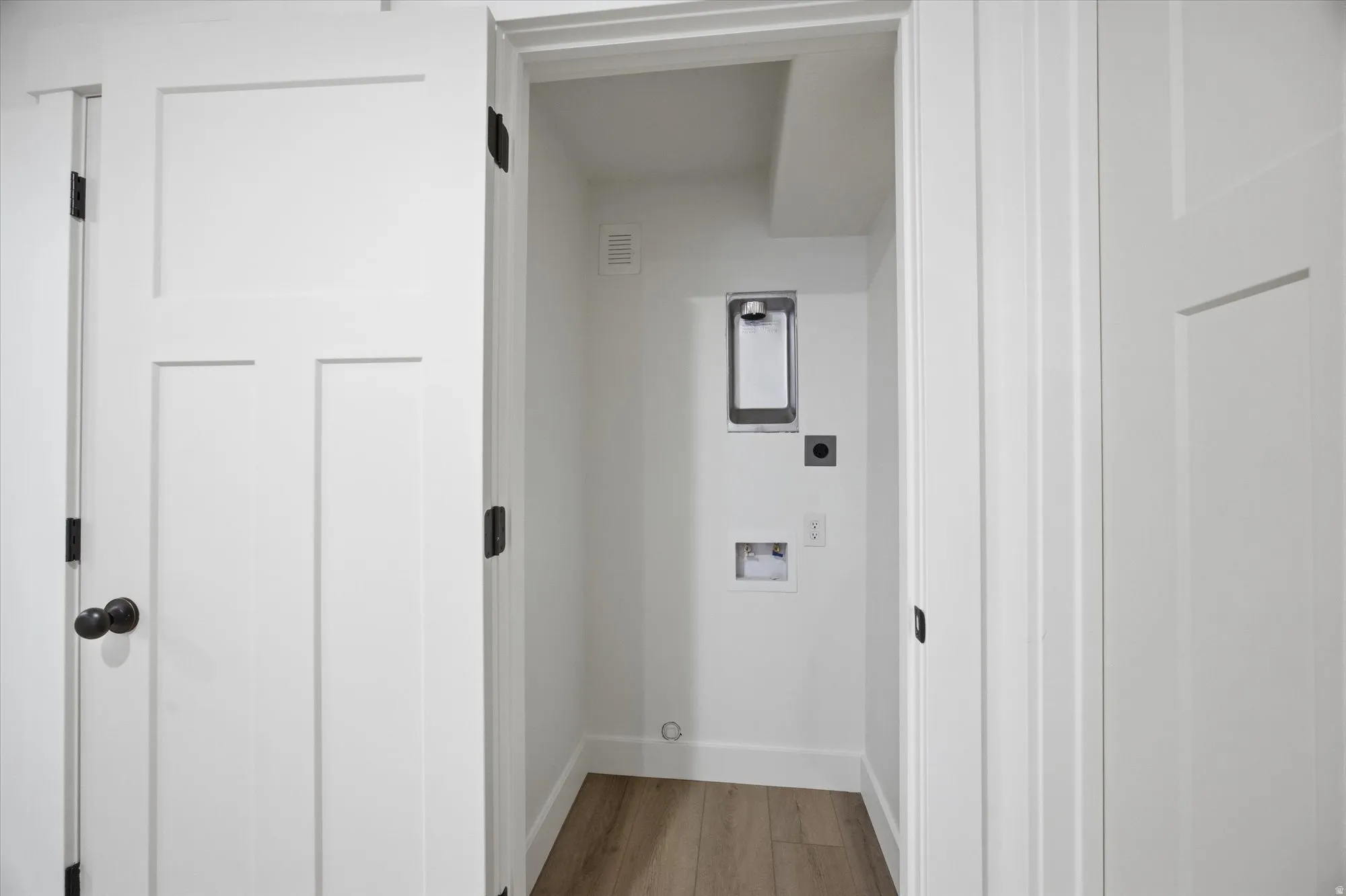 Laundry area featuring light wood-style flooring and washer hookup