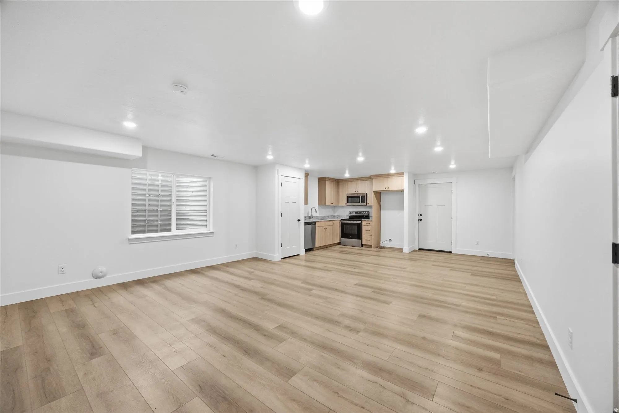 Unfurnished living room with light wood-type flooring and recessed lighting