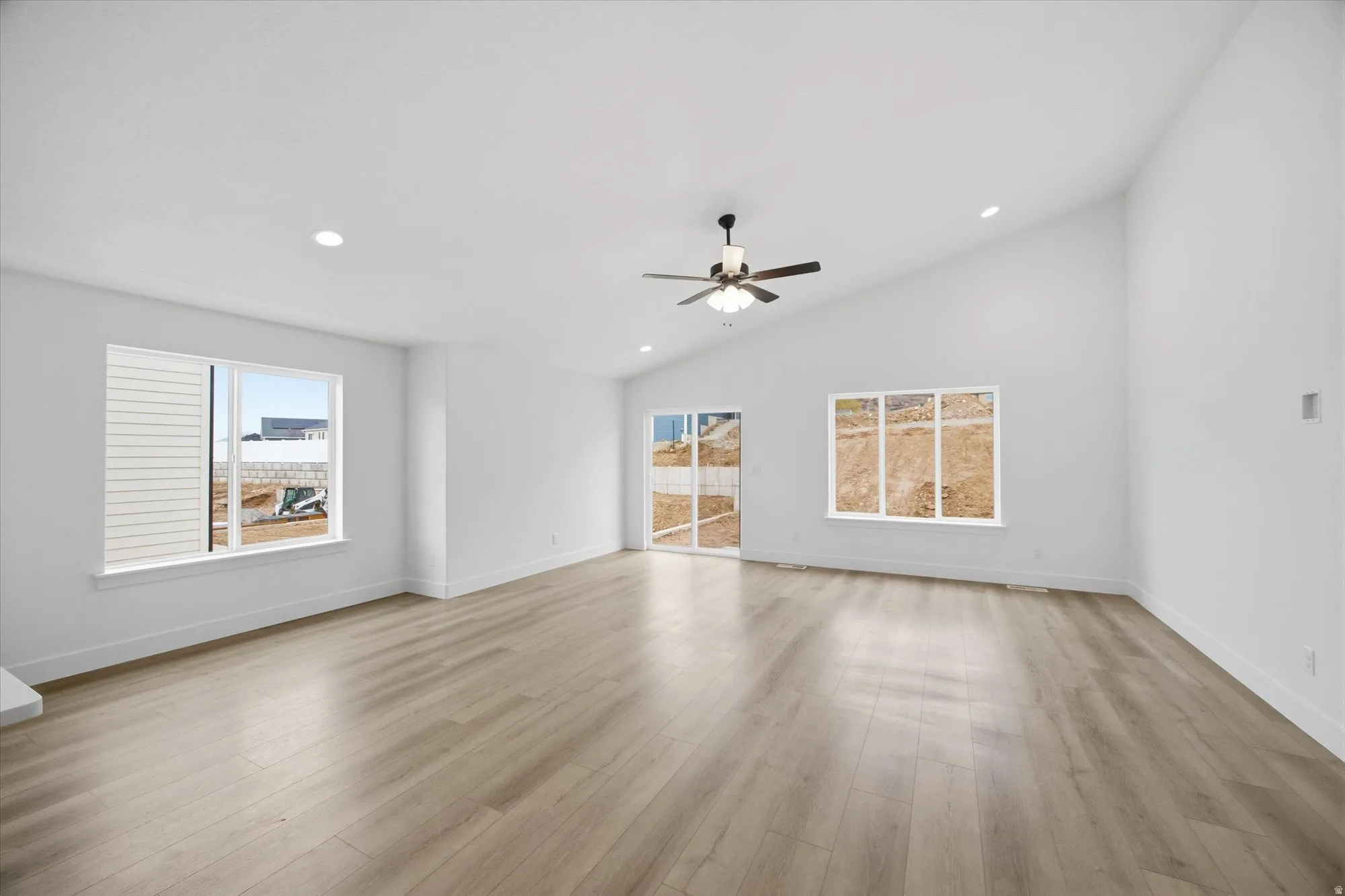 Unfurnished room with recessed lighting, a ceiling fan, lofted ceiling, and light wood-type flooring