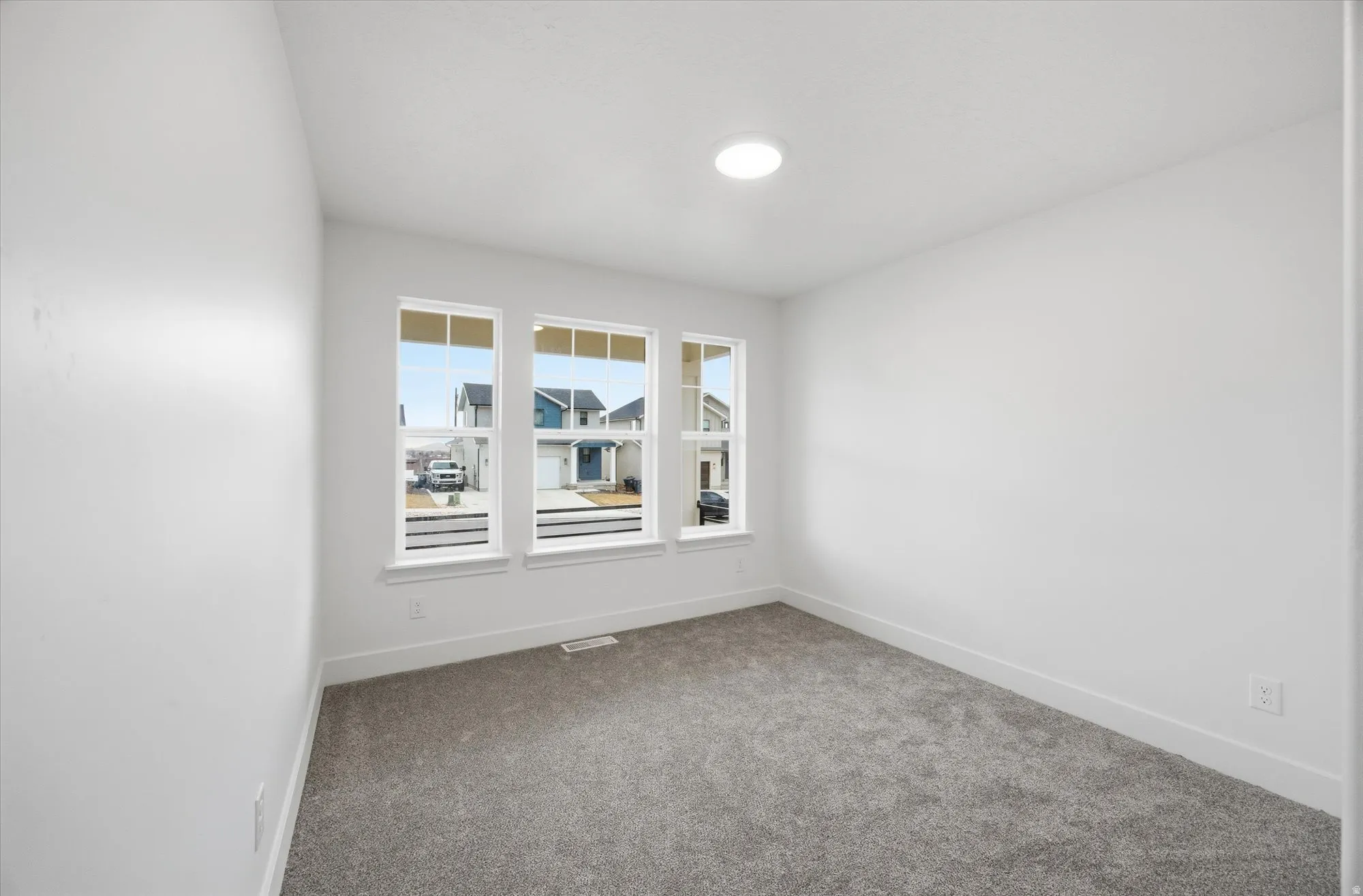 Spare room with carpet and baseboards