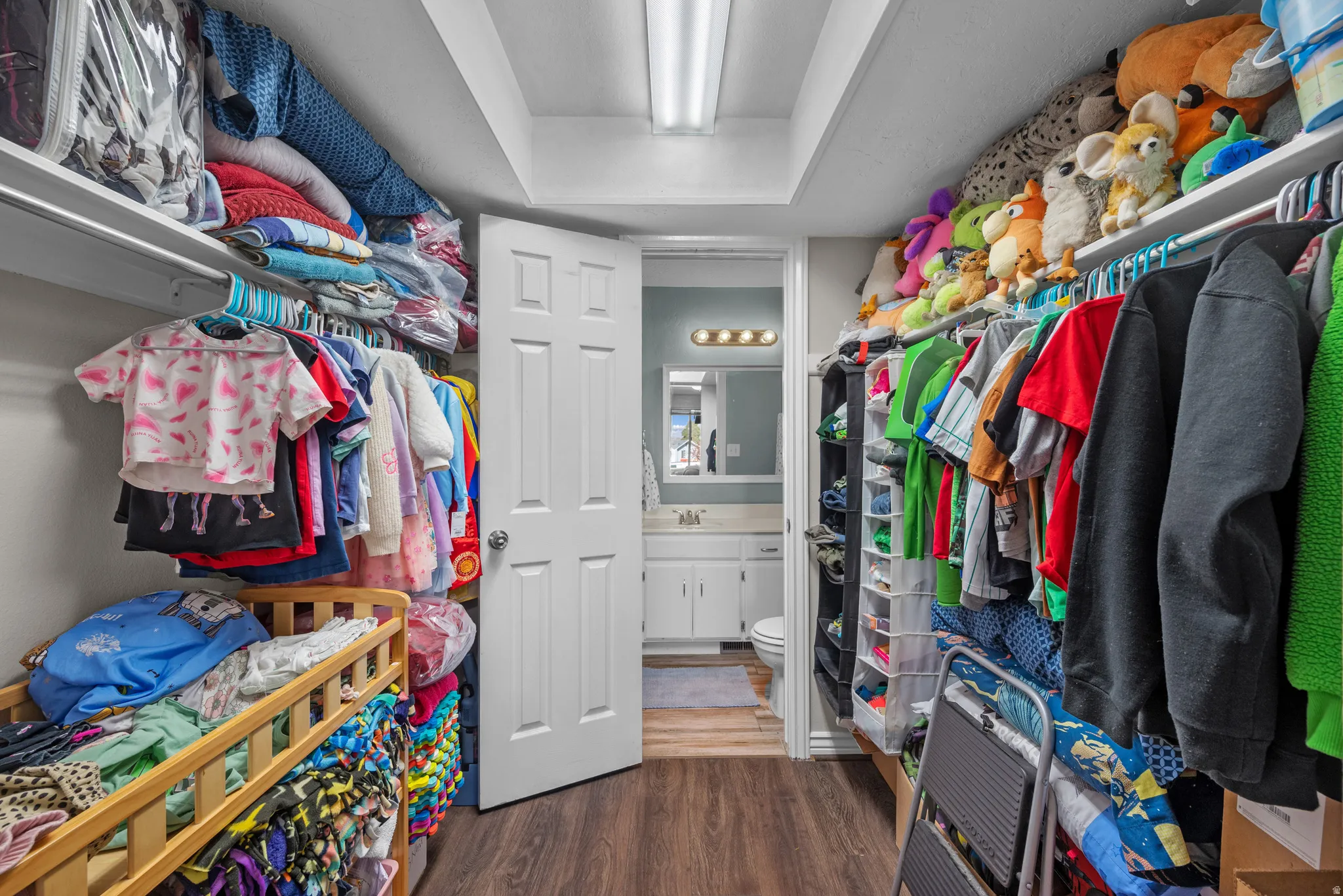Walk in closet featuring dark wood-style floors