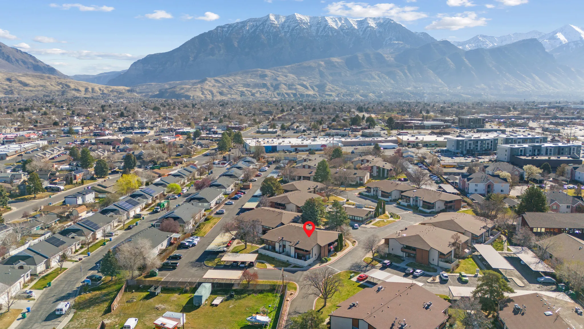 Aerial perspective of suburban area with a mountain backdrop