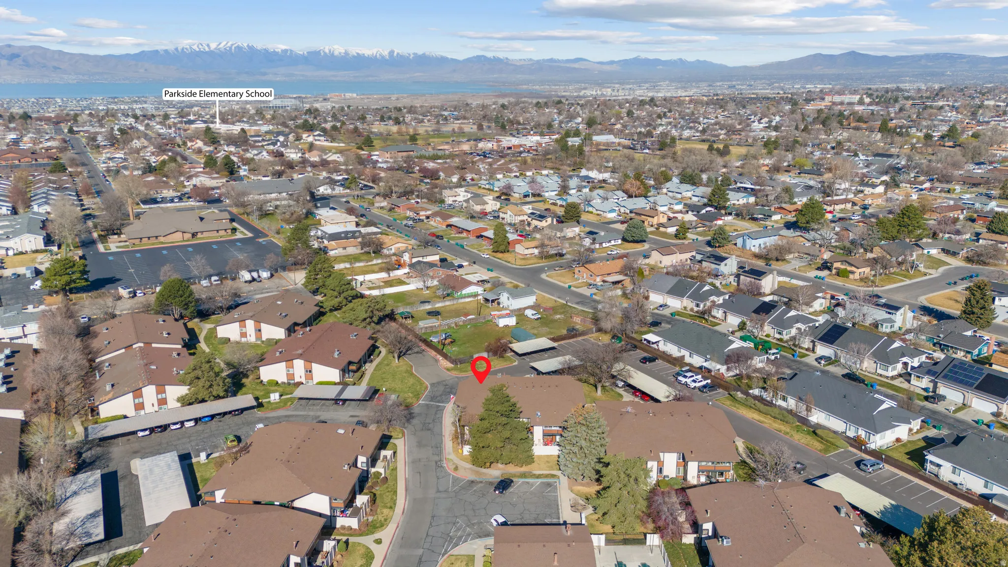 Aerial overview of property's location featuring a mountain backdrop and nearby suburban area