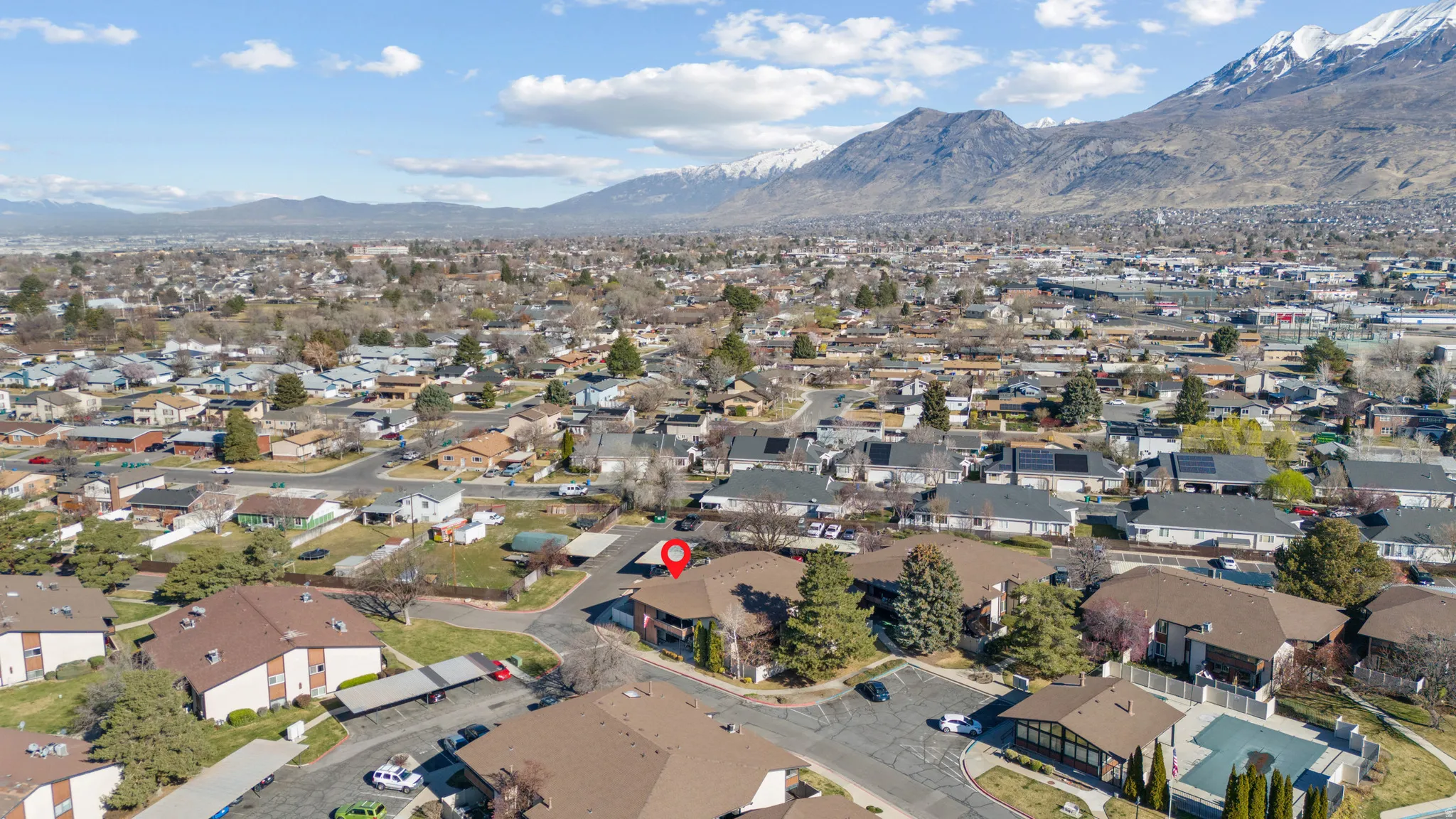 Aerial perspective of suburban area with a mountain backdrop