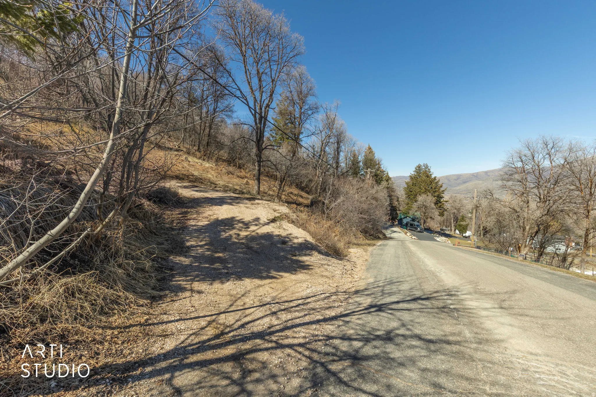 View of asphalt street featuring a mountain view