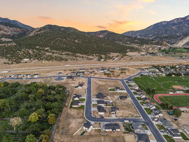 Developing residential neighborhood with newly paved streets, established homes, and mountain scenery