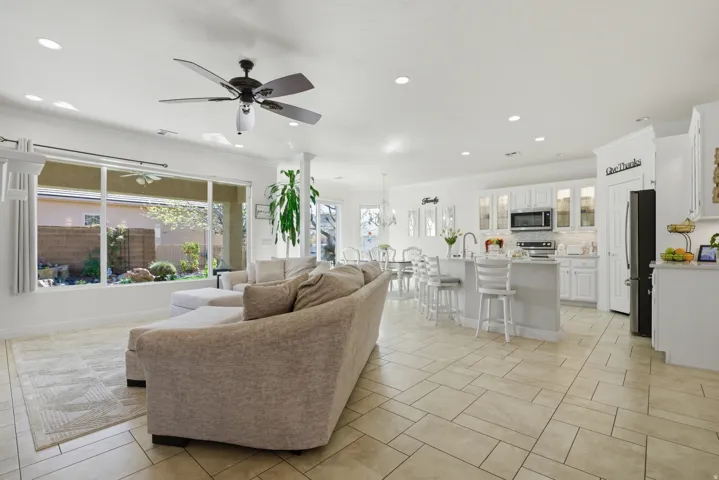 Living area featuring ceiling fan, crown molding, and recessed lighting