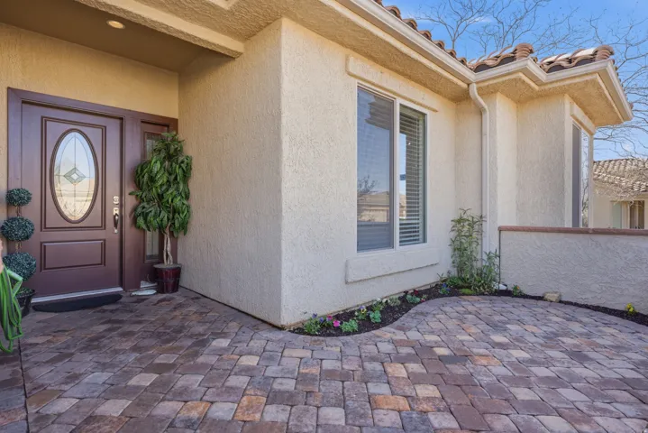 Entrance to property featuring stucco siding and a patio area