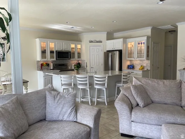 Living room featuring crown molding and recessed lighting
