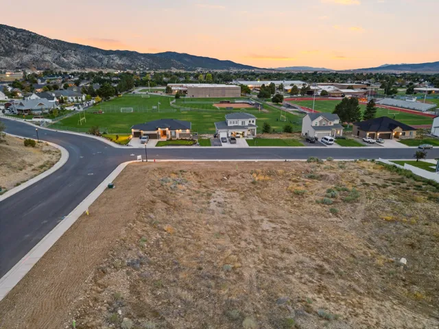Expansive undeveloped lot with paved street frontage and established sidewalks