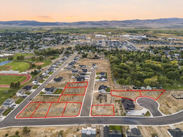 Developed residential lots with infrastructure, mountain backdrop, and proximity to community amenities