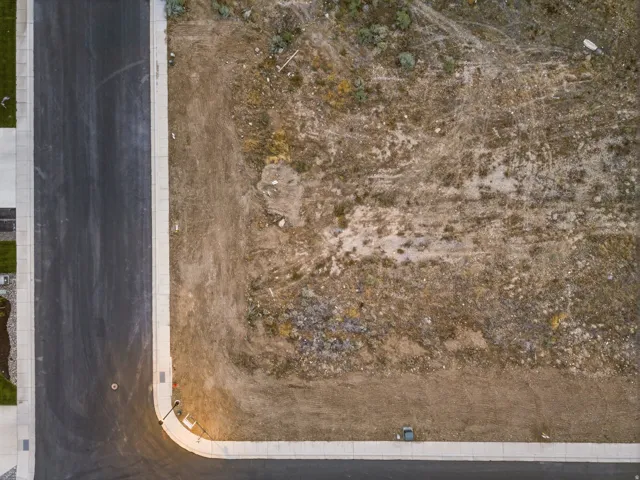 Corner lot with established asphalt roadway and concrete sidewalks
