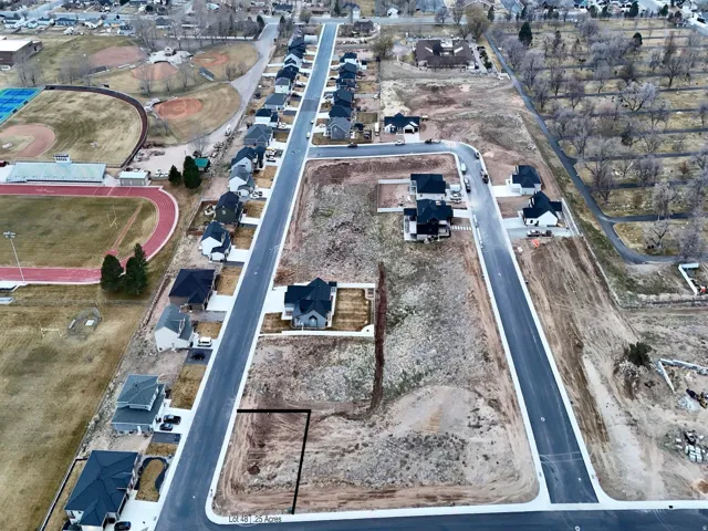 Aerial view of property and surrounding area with nearby suburban area