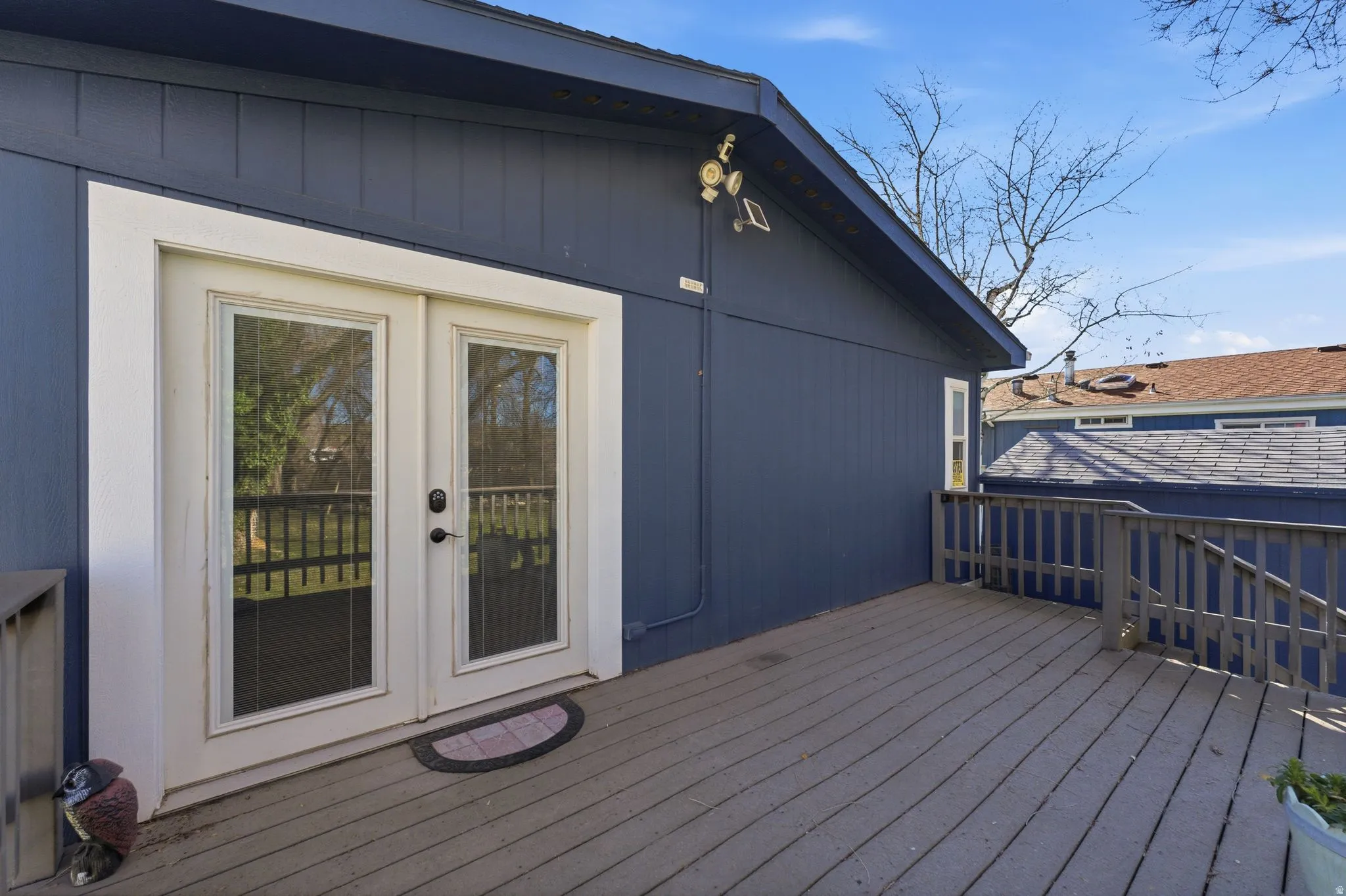 Deck off Primary Suite featuring French doors