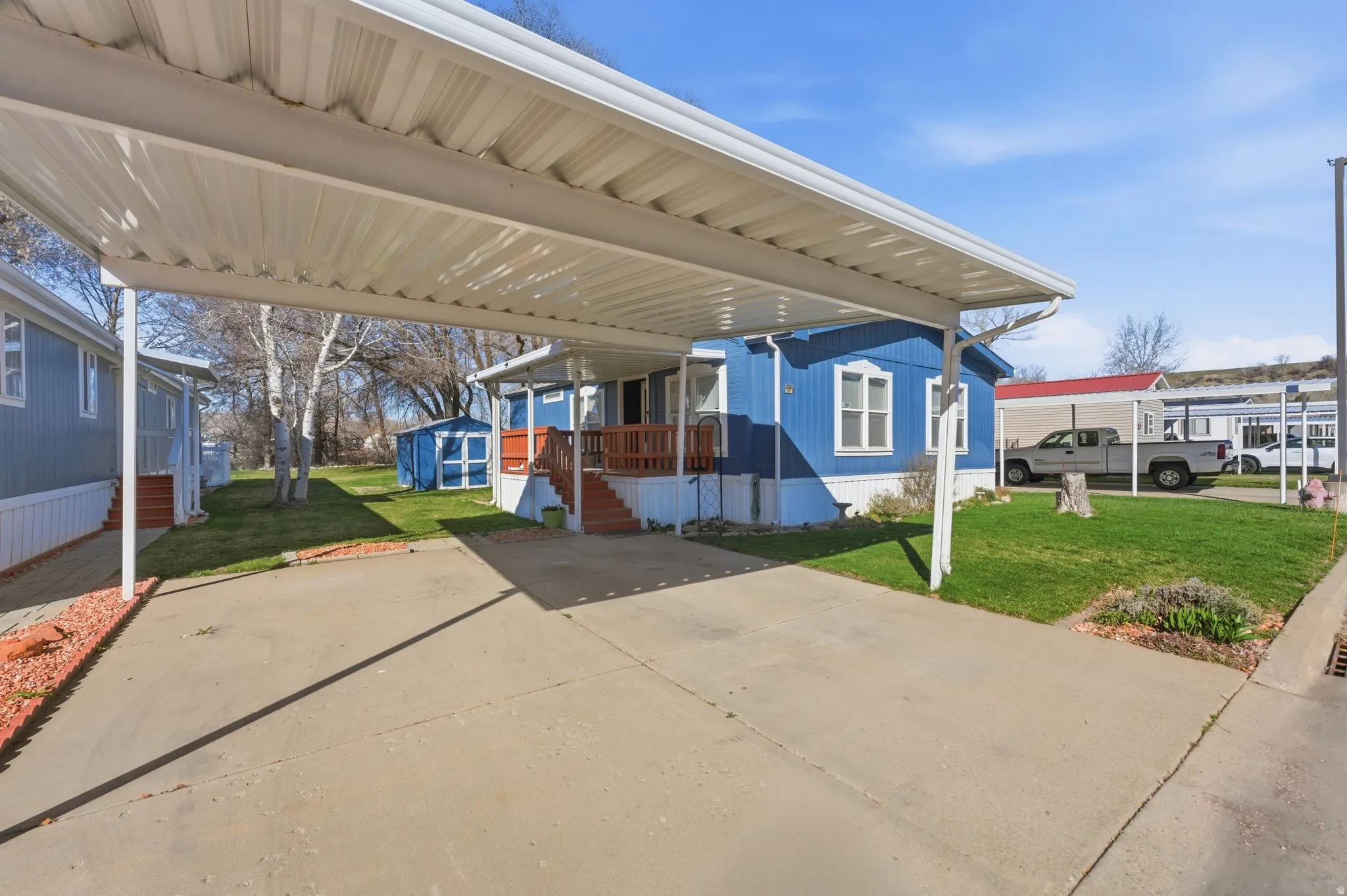 View of patio with a carport and an outdoor structure