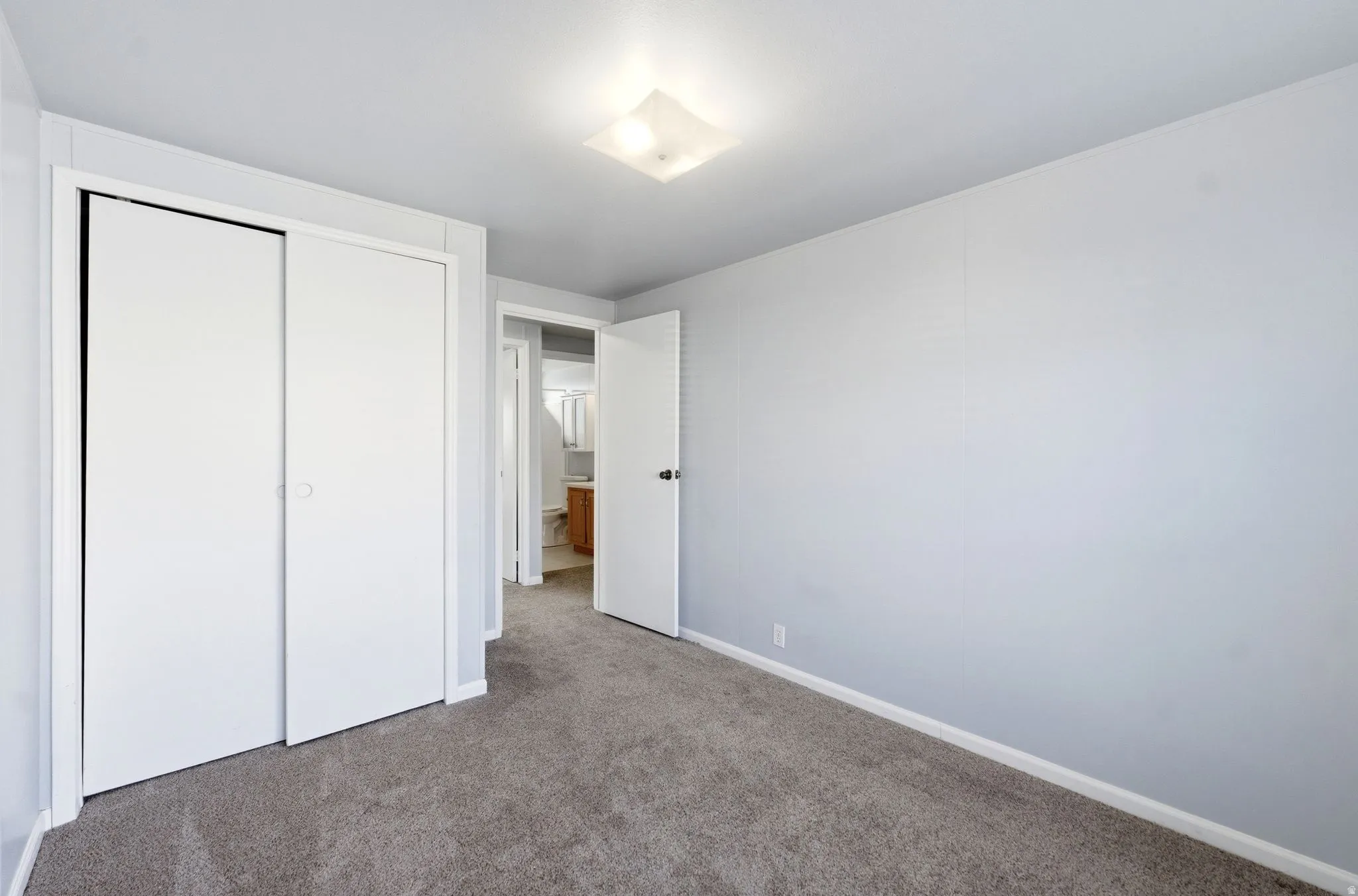Unfurnished bedroom featuring carpet and a closet