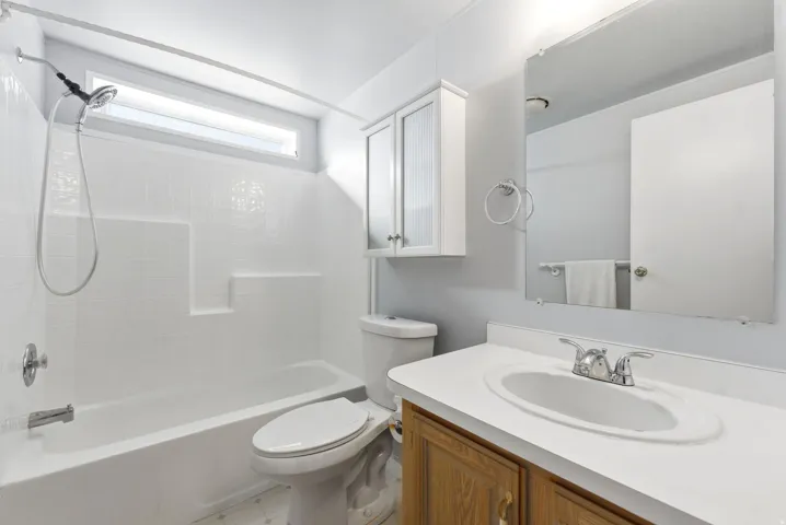 Bathroom with vanity and bathtub / shower combination