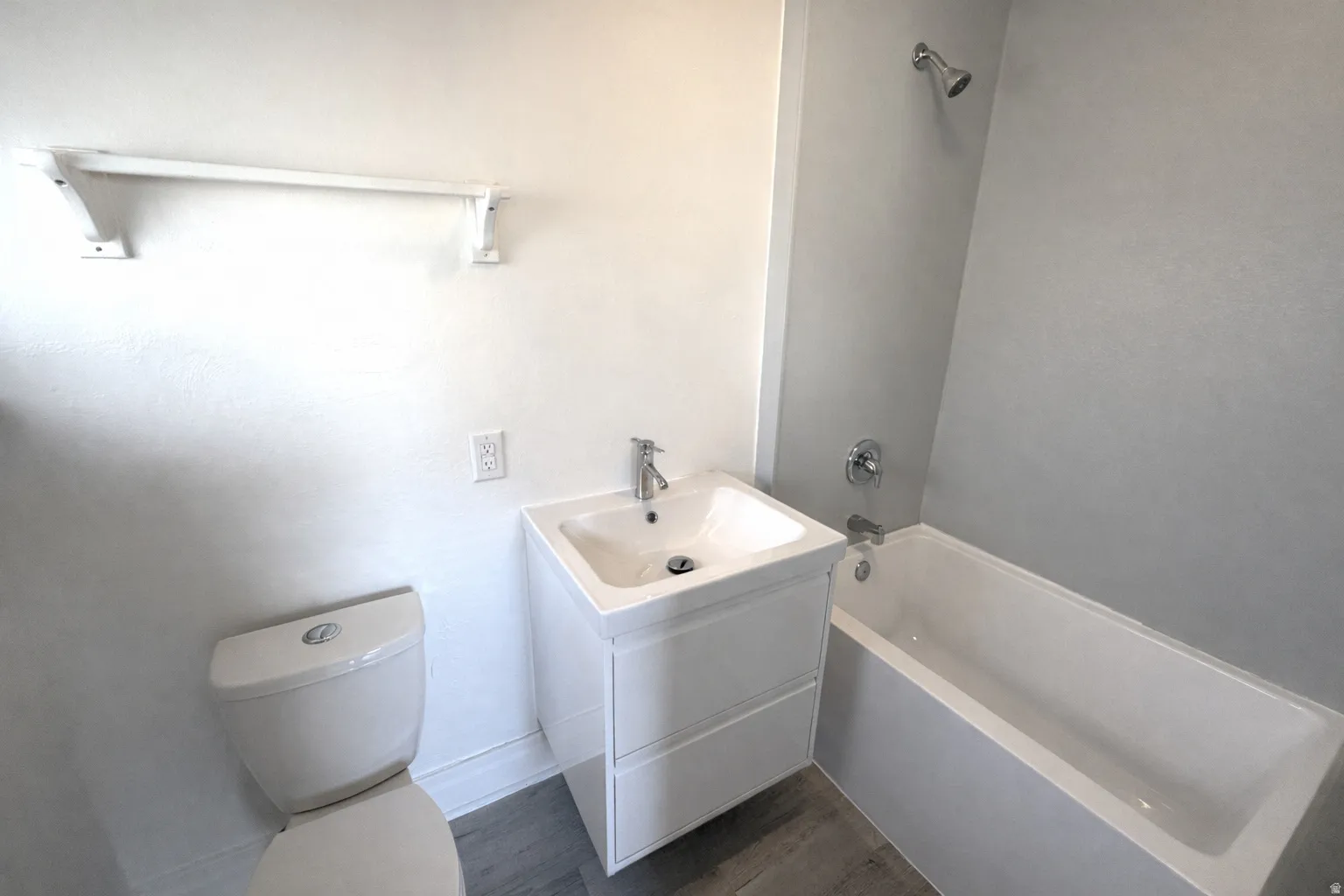 Full bath with vanity, tub / shower combination, and dark wood-type flooring