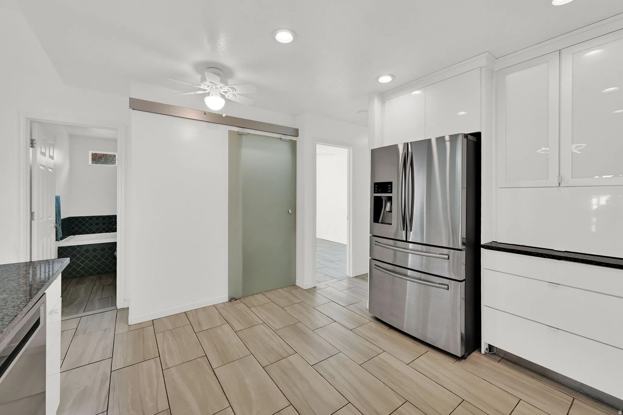 Kitchen with stainless steel appliances, recessed lighting, white cabinetry, a ceiling fan, and title floors