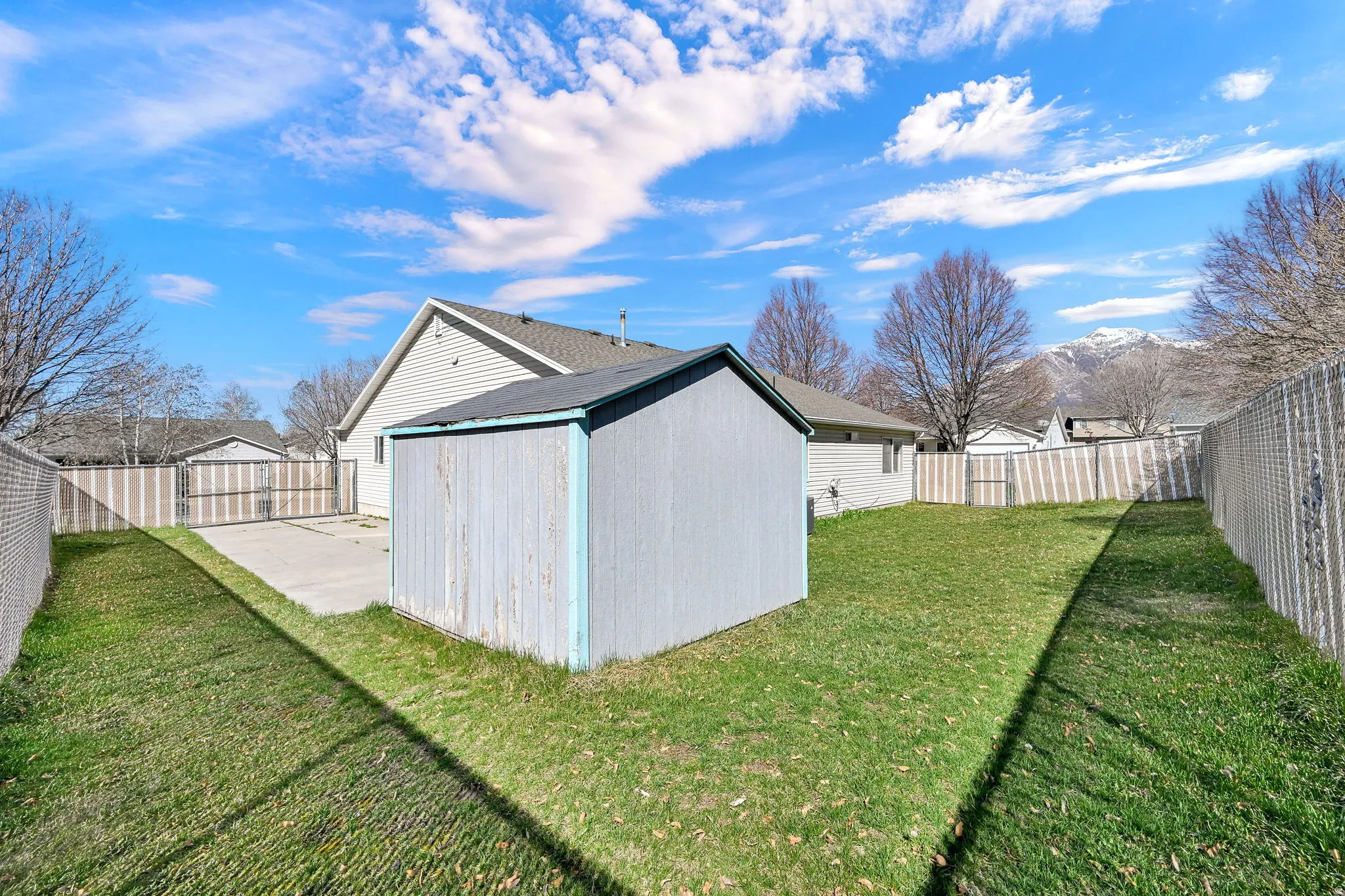 View of outdoor structure with a fenced backyard and a mountain view