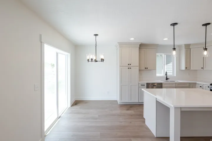 Open-concept kitchen and dining area featuring light wood-finish flooring