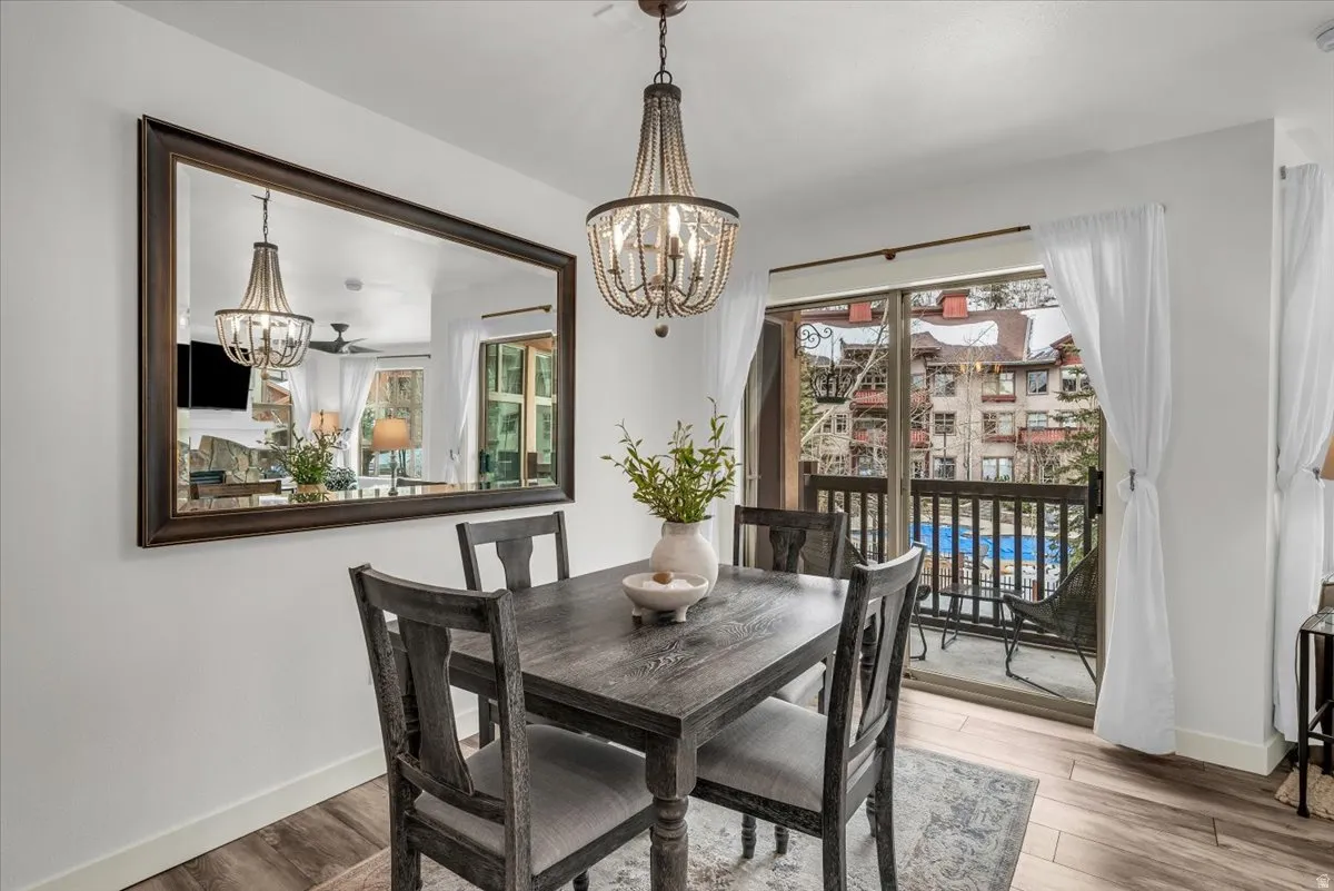 Dining area with deck access and view of community pool.