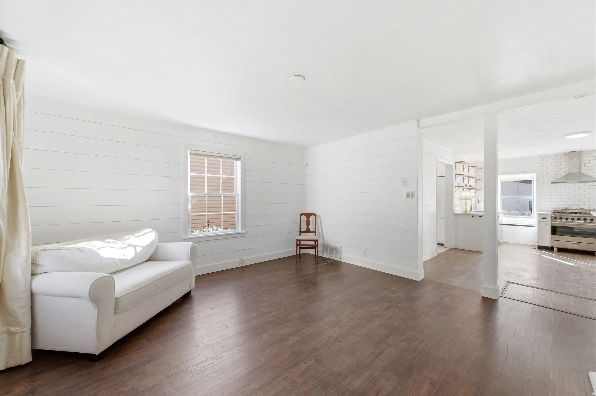 Sitting room featuring dark wood-style floors