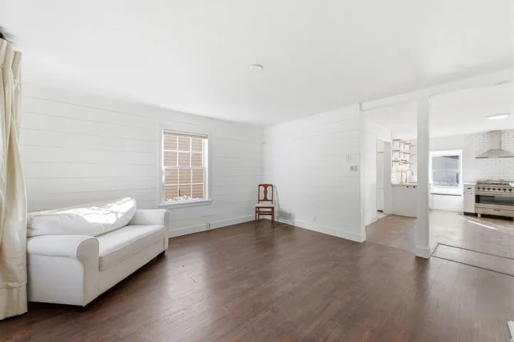 Sitting room featuring dark wood-style floors