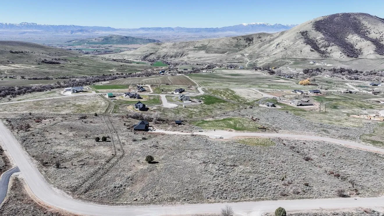 Aerial view of property and surrounding area with rural landscape and mountains