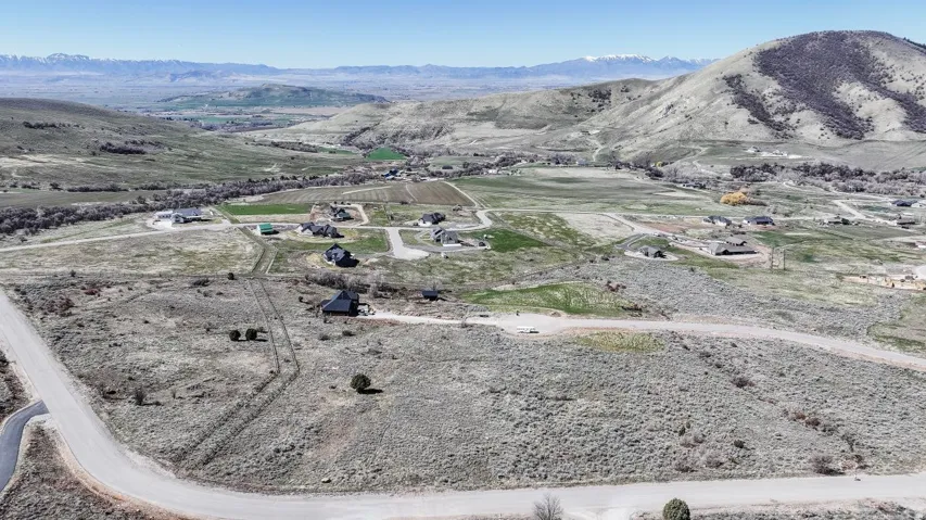 Aerial view of property and surrounding area with rural landscape and mountains
