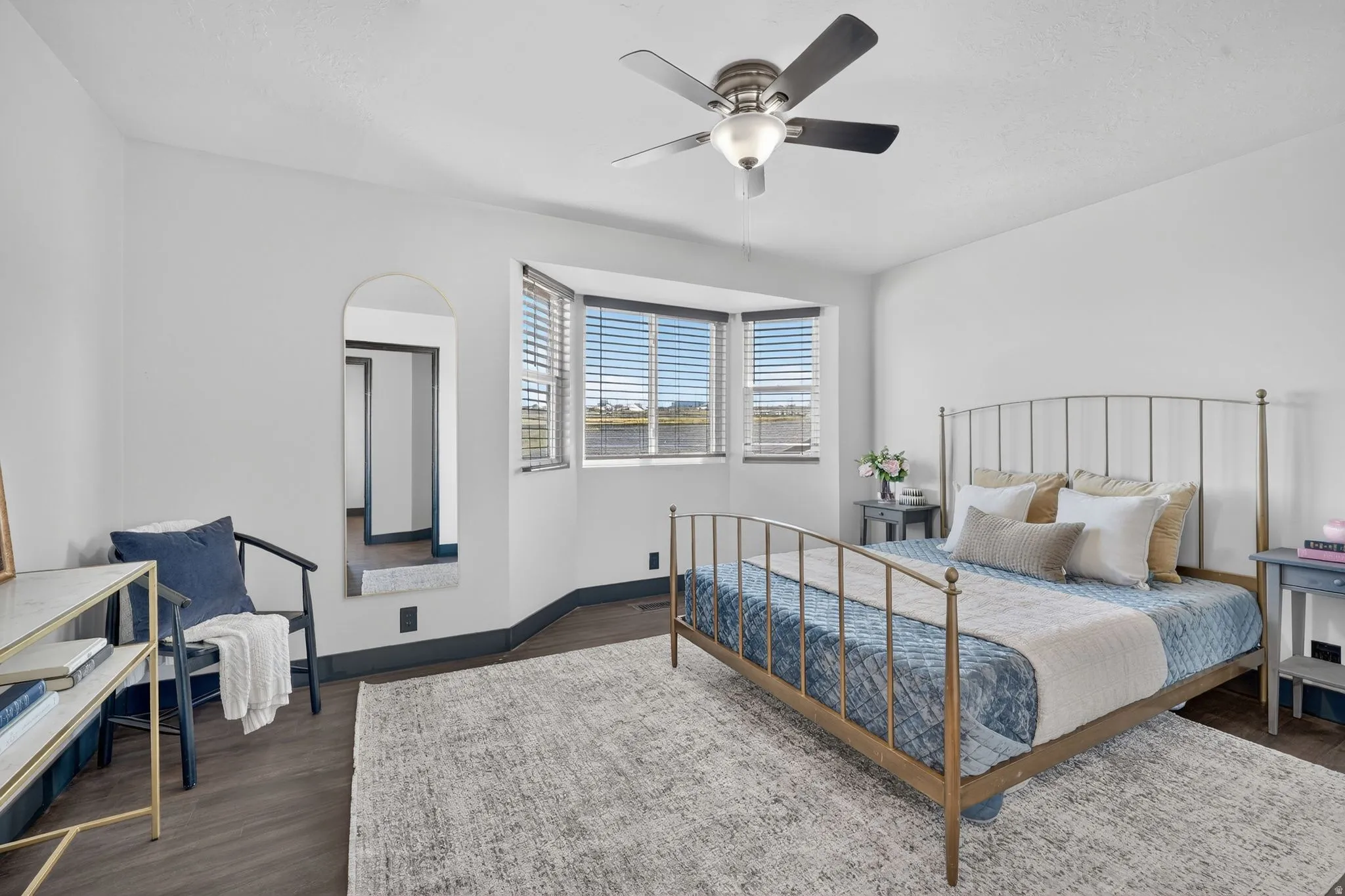 Bedroom with ceiling fan and dark wood finished floors