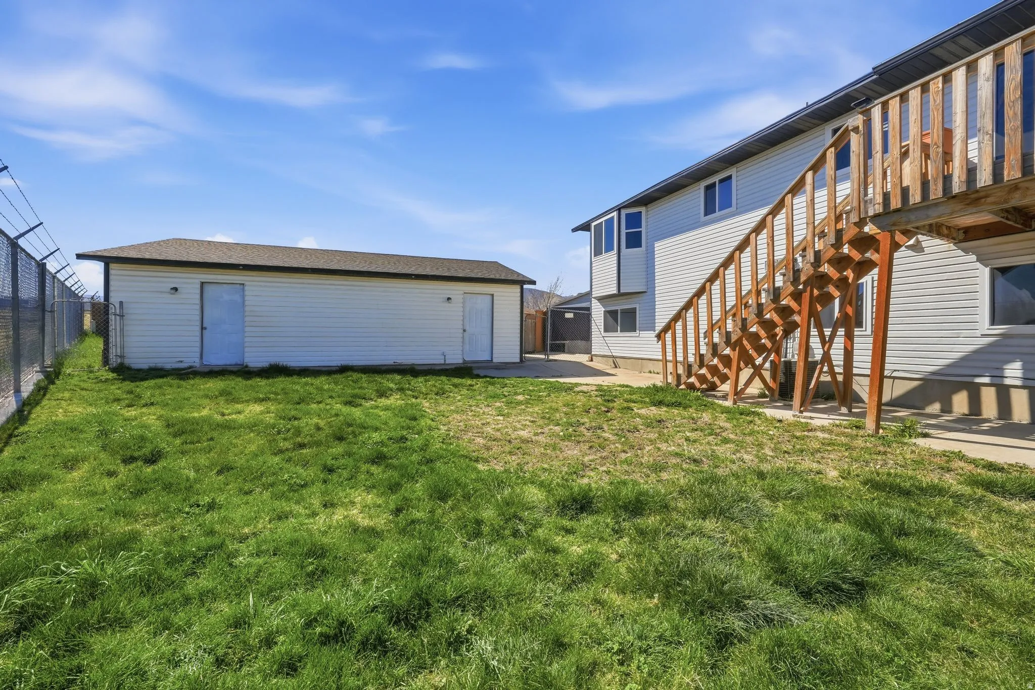 Fenced yard with stairway and a patio