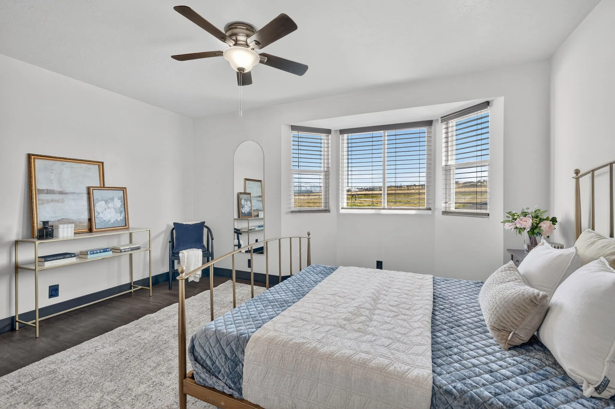 Bedroom featuring wood finished floors and ceiling fan