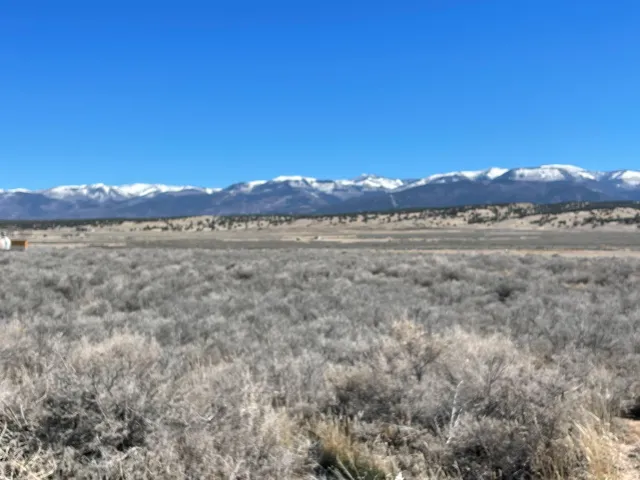 View of mountain backdrop featuring rural landscape