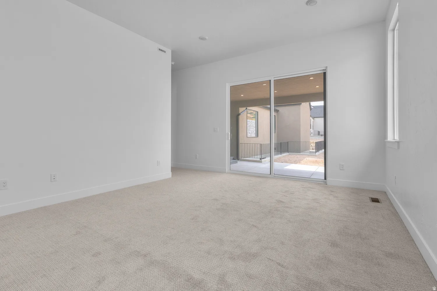 Spare room with light carpet and recessed lighting